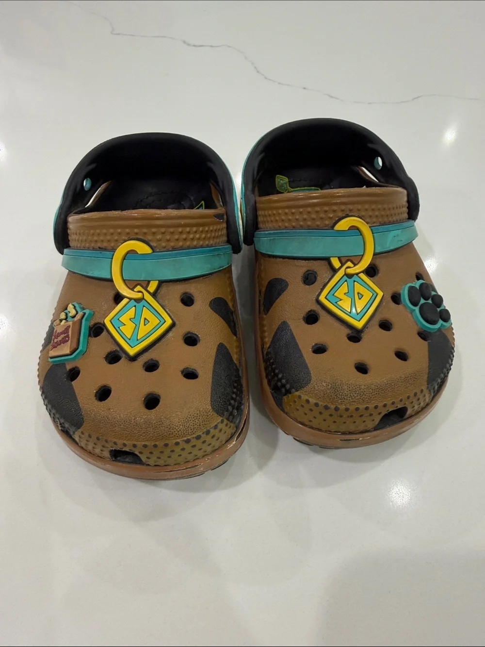 CROCS Kids Brown Clogs with Teal Strap and Yellow Charm Accents
